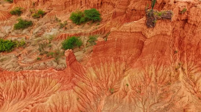 Aerial high angle drone footage of the eroded red rock formations and canyons of the tatacoa desert in huila, colombia