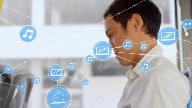 Animation of network of connections with icons over asian businessman using smartphone