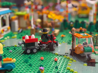 Naklejka premium Lego tractor with egg trailer on green baseplate
