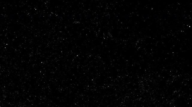 Animation cinematic film dust and heavy grain texture overlay on black background. Vintage style grunge motion effect features realistic white particles, scratches and fibers, perfect for adding an an