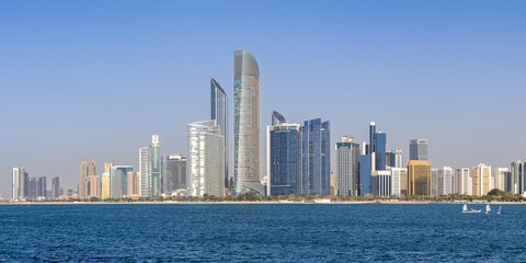 Fototapeta premium Abu Dhabi skyline with skyscrapers panorama at sea in Abu Dhabi, United Arab Emirates