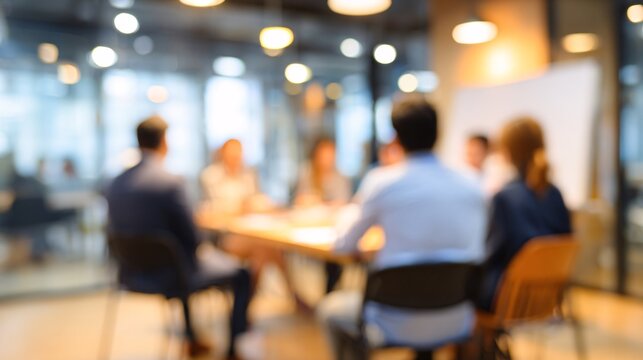 Blurry business meeting with team discussing ideas in modern office