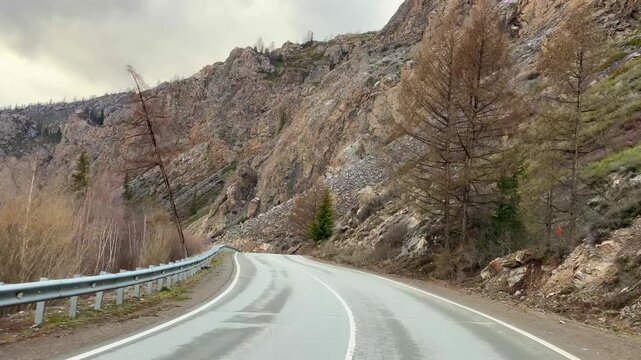 Road of Chuysky Trakt running along Katun River Altai Russia. Scenic route following Siberian mountain river through natural landscape.