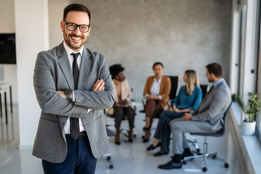 Group of young business people working as a team and communicating in corporate office