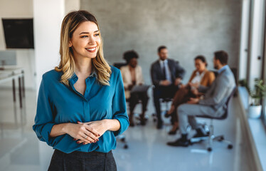 Young happy successful business woman working in corporate office