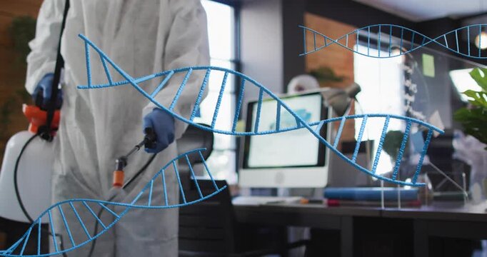 Sanitation tech entering office and activating sprayer, misting desk while blue DNA helix floating
