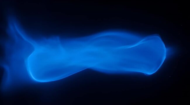 Abstract ethereal depiction of bright blue smoke set against a dark background