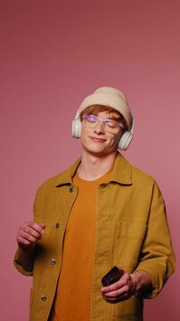 Young man selecting music on his phone and listening with headphones