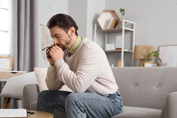 Fototapeta premium Religious man praying at home