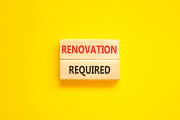 Naklejka premium Renovation required words symbol. Concept words Renovation required on beautiful wooden blocks. Beautiful yellow background. Business and Renovation required words concept. Copy space.