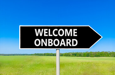 Welcome onboard symbol. Concept words Welcome onboard on beautiful black road sign. Beautiful blue sky green grass field background. Business, motivational welcome onboard concept. Copy space.