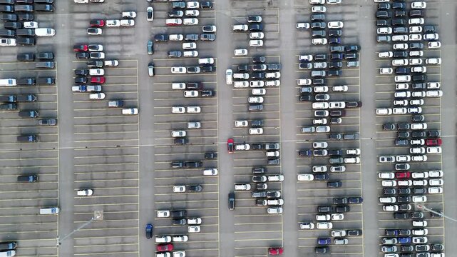 Higher aerial view of vehicle blocks vans and storage layout emphasizing large scale automotive distribution.