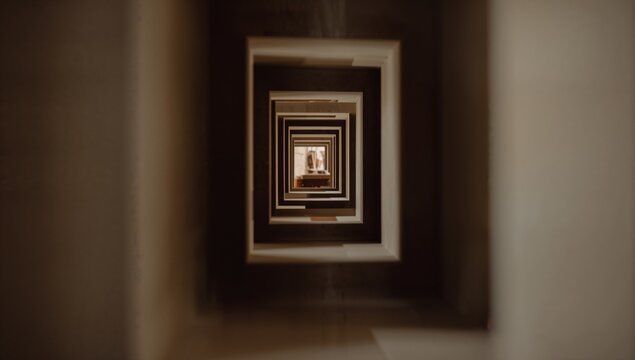 Framing vertical light well forming tunnel in atrium, with concentric frames, central aperture