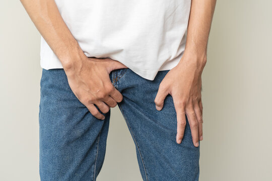 men feeling itching and scratching his crotch