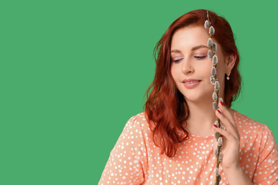 Beautiful young woman with pussy willow branch on green background. Easter celebration