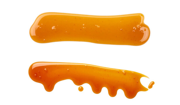 A close-up view of two golden liquid splatters on a black background