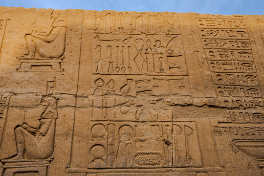 Ancient Egyptian hieroglyphs carved on sandstone wall at Edfu Temple