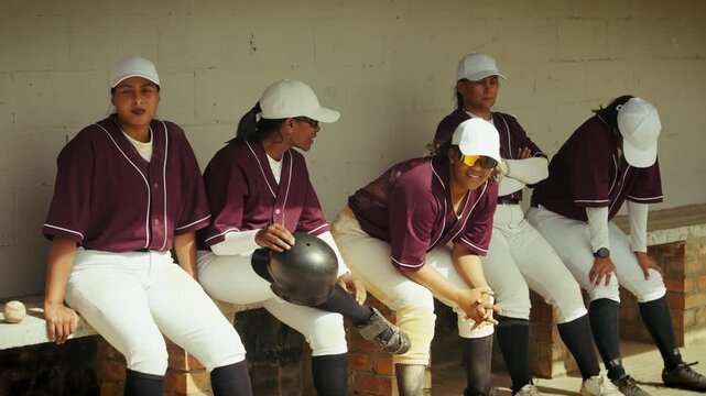 Women's baseball team rests in the dugout