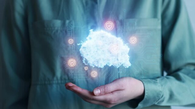 Cloud computing concept is shown with a hand holding a digital cloud symbol for data security and technology in a modern setting.