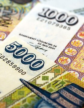 Icelandic krona money bills pile on table. Iceland banknotes of ISK currency close up. Concept of business, economy and banking in Iceland