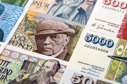 Icelandic krona money bills pile on table. Iceland banknotes of ISK currency close up. Concept of business, economy and banking in Iceland