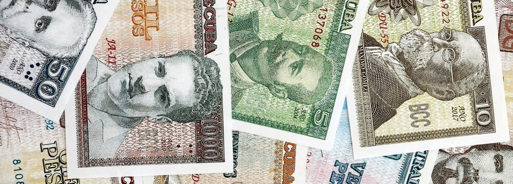 Cuban peso money bills pile on table. Cuba banknotes of CUP currency close up. Concept of business, economy and banking in Cuba