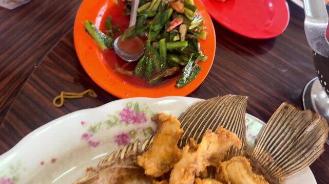 Footage of Chinese Restaurant Table with Deep Fried Fish, Stir Fried Chinese Greens, Fried Rice and Soup on Lazy Susan.