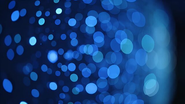 Blurry bokeh lights in shades of blue against a dark background, creating a dreamy effect