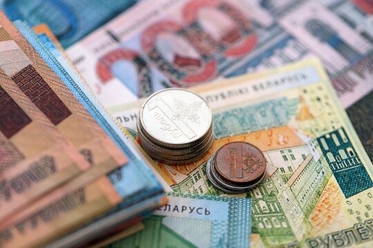 Belarusian ruble money bills and kopek coins pile on table. Belarus coins on banknotes of BYN currency close up. Concept of business, taxes and banking in Belarus