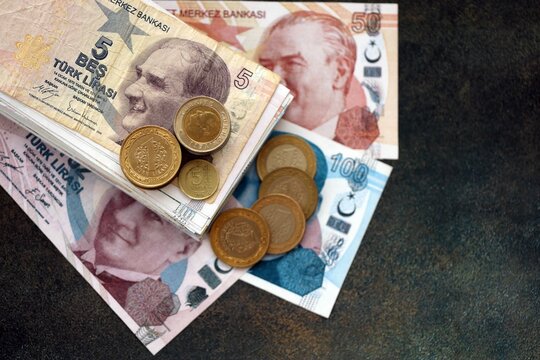 Turkish lira money bills and kurus coins pile on table. Turkey coins on banknotes of TRY currency close up. Concept of business, taxes and banking in Turkey