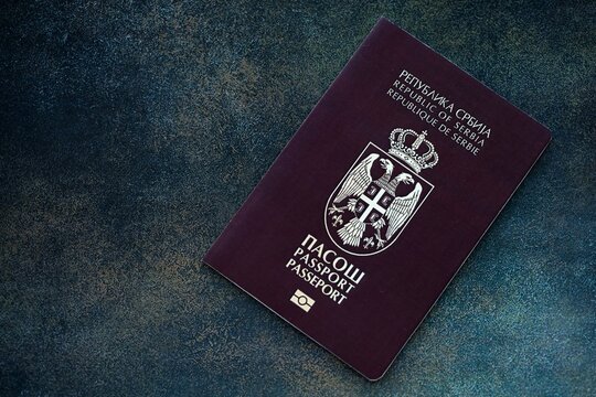 Serbian passport on table close up. Official identification document book for citizens of Serbia. Concept of travel and tourism in Serbia