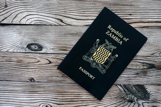 Zambian passport on table close up. Official identification document book for citizens of Zambia. Concept of travel and tourism in Zambia