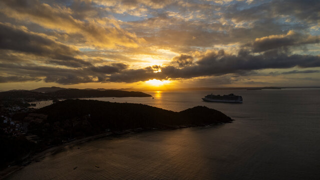 Golden sunset in B&uacute;zios with cruise ship seen from Jo&atilde;o Fernandes beach Rio de Janeiro Brazil &ndash; tropical travel destination