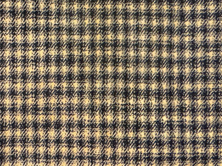 Fototapeta premium Close up of fabric with tartan pattern. In brown and white color. Flannel or tartan style is very common in scarf, shirts, and fashion industry. Seamless background texture.