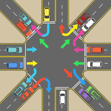 Busy intersection with cars making various turns and traffic flow arrows