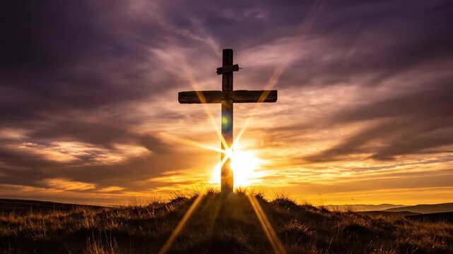 wooden cross on grassy hill against dramatic sunset sky with golden light. easter resurrection concept. christian faith and hope. religious background, church presentation, greeting card.