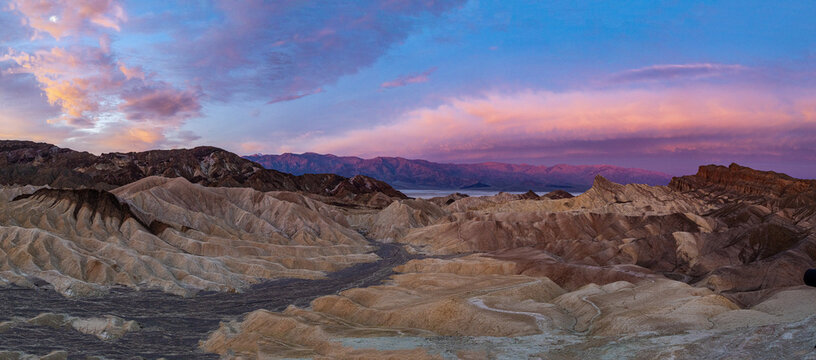 Zabriskie Point, Death Valley: Badlands glow under vibrant sunset.