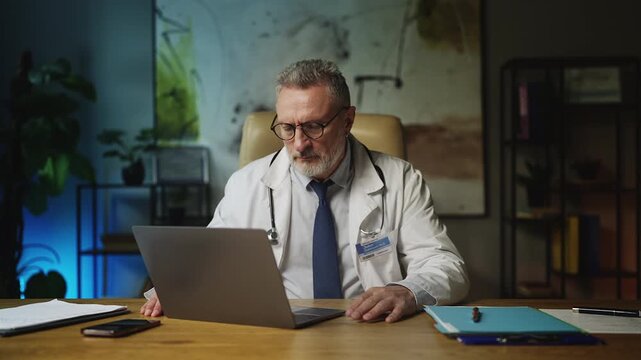 Overworked male cardiologist feeling tired after difficult workday, burnout