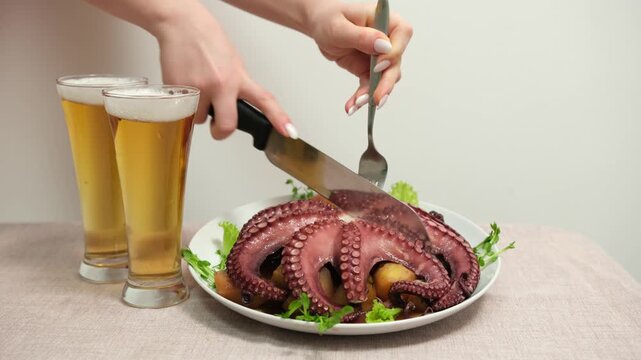 eating dinner with friends in modern restaurant, roasted octopus, potatoes and vegetables. High quality 4k footage