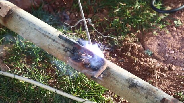 Welding process with bright sparks and smoke