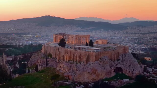 Panoramic aerial view of the Parthenon Temple at the Acropolis of Athens, Greece, during sunset time with the city skyline in the background