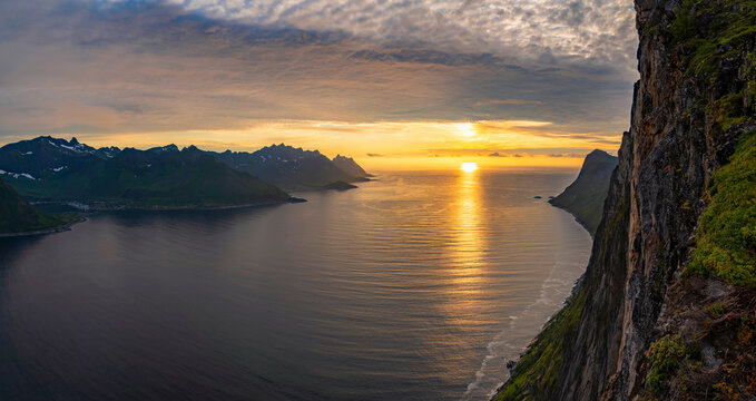 View from the mount Hesten on iconic mountain Segla in a summer sunny evening. Mountain ranges at the background. Fjordgard, Senja island, Norway. Summer vacation in Lofoten