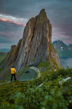View from the mount Hesten on iconic mountain Segla in a summer sunny evening. Mountain ranges at the background. Fjordgard, Senja island, Norway. Summer vacation in Lofoten