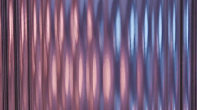 Abstract background of vertical ribbed texture with pink and blue light reflections