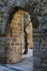 Obraz premium Old, stone arch in the interior of the fortress São Jorge Castle, sometimes known in English as Saint George's Castle, a historic castle in the Portuguese capital of Lisbon.