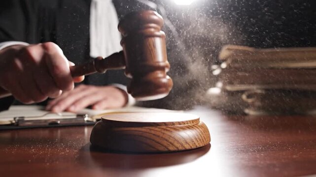 Judge gavel strike wooden block law court decision justice system close up