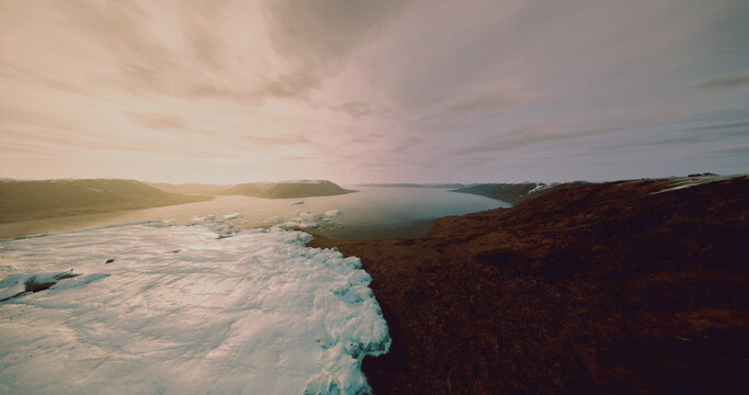 Ice melting landscape, Melting ice along rugged shoreline viewed from above, Aerial perspective of shrinking ice and thawed channels along harsh coastlines