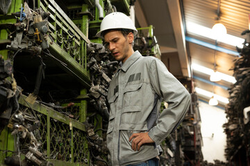 Fototapeta premium Technician worker feeling tired and frustration from working in garage scrap yard car workshop warehouse.