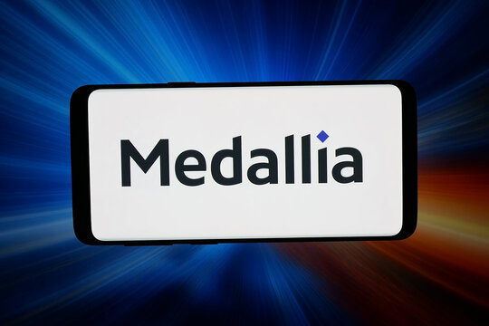 Stuttgart, Germany - 03-13-2026: In this photo illustration, the logo of experience management company Medallia Inc. is displayed on a smartphone in front of abstract background on computer screen.
