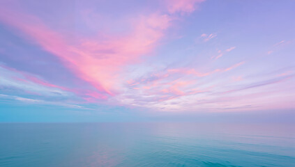 Serene pastel sky with pink and purple clouds over a calm ocean horizon
